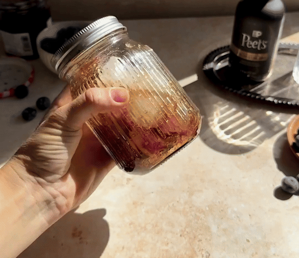 Closeup hands making a blueberry latte with Peet's ultra concentrate